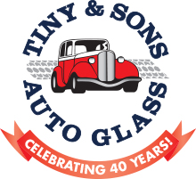 Red roadster icon surrounded by Tiny & Sons Auto Glass, with a ribbon beneath that says Celebrating 40 years!